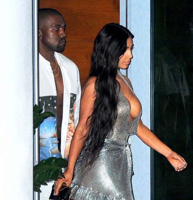 Kim Kardashian bares major side cleavage as she and Kanye West leave their hotel to go to his concert in Miami.